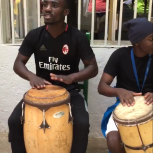 two boys drumming in Haiti