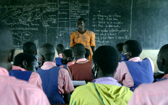 Secondina Akidi with her pupils at Burlobo primary school ni Lira district, Northern Uganda
