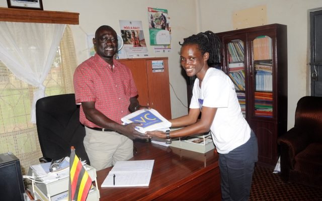 Patrick (left) being handed a VC t-shirt by VC Staff Member Rose